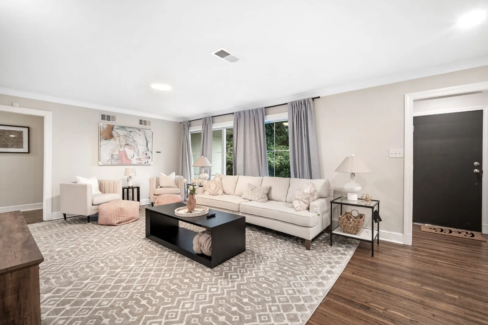 Staged living room in a fully renovated Memphis home — finished walls, trim, recessed lighting and finished flooring