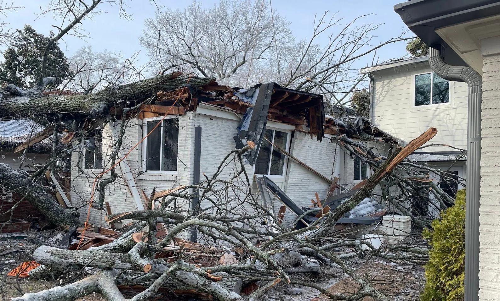 Damaged roof deck and broken framing after a severe ice storm